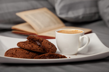 Morning coffee with chocolate cookies in bed
