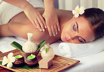 Plakat Body care. Spa body massage treatment. Woman having massage in the spa salon