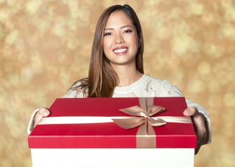 beautiful young asian woman holding present