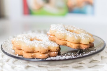 Homemade apricot jam Linzer with icing sugar close up