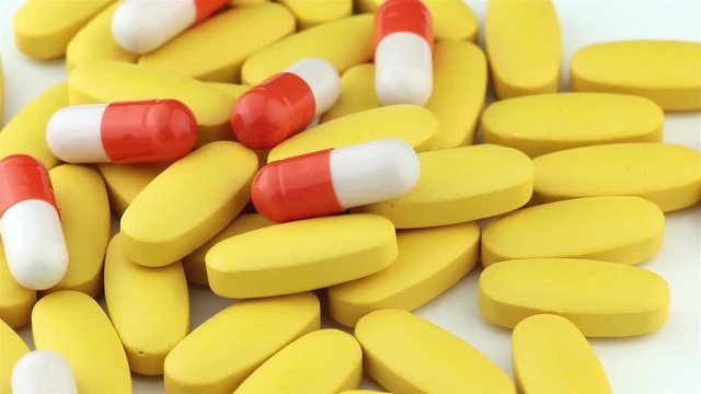Heap of vitamin pills, rotation. Health care and medicine