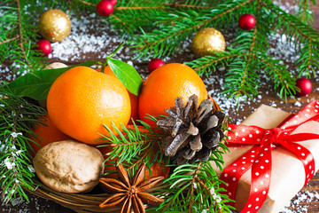 Tangerines, fir tree, pine cones and nuts. Christmas food decorations