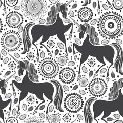 Fairytale pattern with  unicorns on a floral background. Black and white vector illustration.