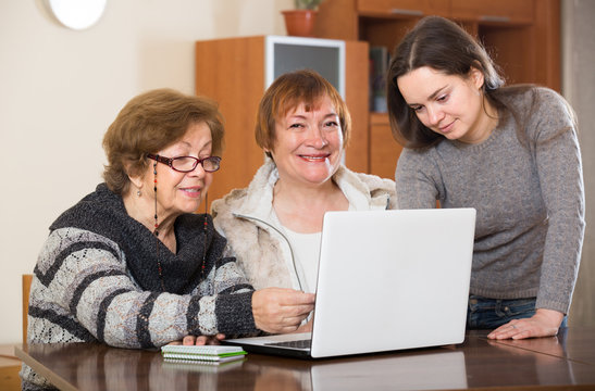 pensioners and relative with laptop