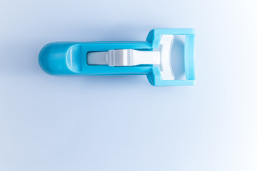 Close-up of Blue plastic Curler on clear background with copy space