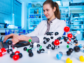 Woman scientist holding model of molecule or crystal lattice. scientist working at the laboratory....