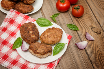 Homemade meat cutlets  in plate on  wooden table
