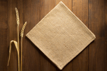 ears of wheat and cloth on wood