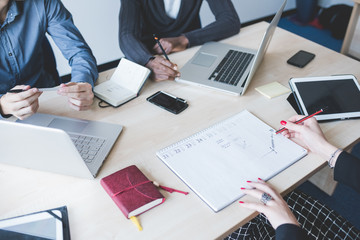 Top view of an office desk with a group of people working using technological devices - work, business, teamwork concept