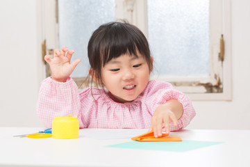 折り紙で遊ぶ子ども