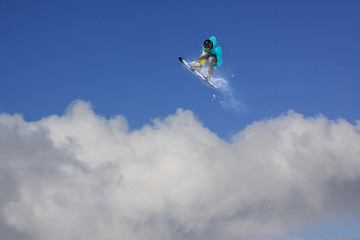Obraz na płótnie Canvas Snowboard rider jumping on mountains. Extreme snowboard freeride sport.