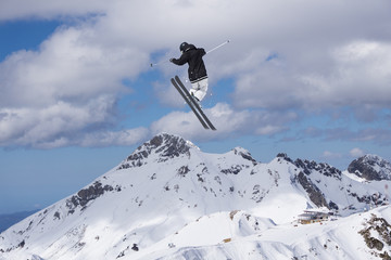 Naklejka na ściany i meble Skier jump on mountains. Extreme sport.