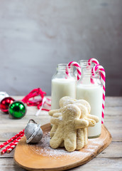 Milk in the bottles and cookies on rustic wood table. C