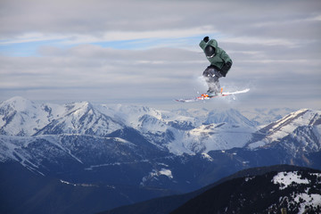 Naklejka na ściany i meble Skier jump on mountains. Extreme sport.