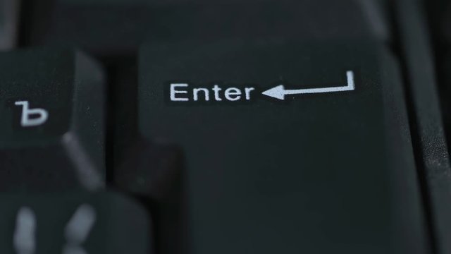 The man pressing the enter key