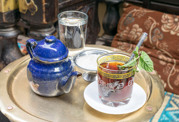 Traditional mint tea set on copper table in an oriental cafe at Khan El Kalili Bazar, Cairo, Egypt