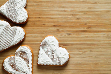 Valentine white gingerbread in the shape of a heart on a wooden board