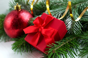 Red christmas ball,present and fir branch on white background