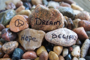 Peace Sign, Dream, Hope, and Believe Written on Stones
