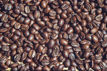 roasted coffee beans on the surface closeup top view, background