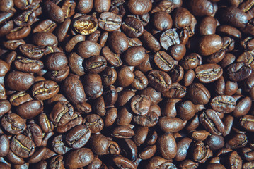 roasted coffee beans on the surface closeup top view, background