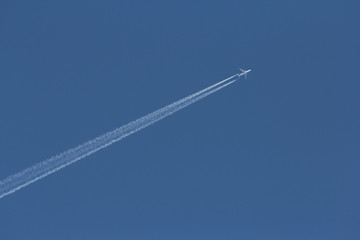 white jet plane on blue sky