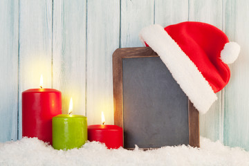 Obraz na płótnie Canvas Christmas candles and chalkboard