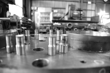 Sheet Metal Stamping Tool Die. Progressive Stamping System. Black and White Photography.