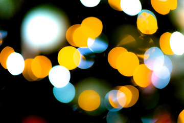 Vibrant coloured lights blinks defocused Christmes tree backgrou