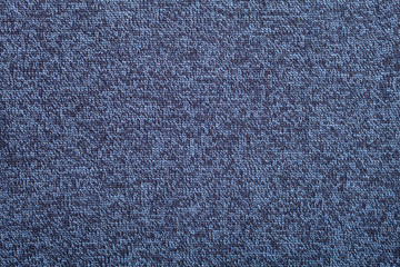 Blue knitted fabric made of heather yarn textured background