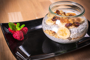 Chia seed pudding with nuts and slices of banana. Healthy dessert