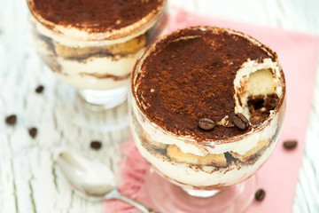 Italian dessert tiramisu in glass, sweet food