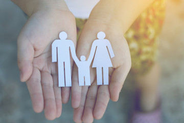 Children hands holding small model of heart and family , concept