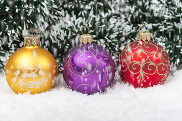 Christmas background with a red and blue ornament, golden gift box, Angels, berries and fir in snow on forest backround