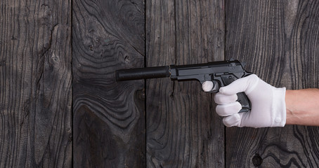 with a pistol with a silencer hand