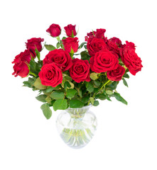 Bouquet of dark red rose buds with green leaves in glass vase isolated on white background