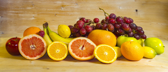 mix of fruits on wooden background