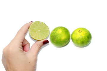 green lemons in hand