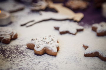 Christmas gingerbread cookie tree with flour on purple backgroun