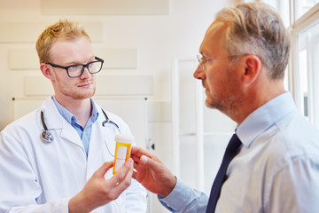Arzt gibt älterem Patient ein Medikament