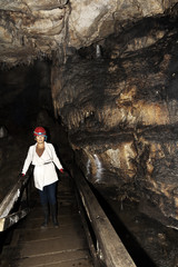 Woman walks out of Lepenica cave in Bulgaria in the fall
