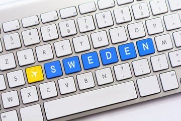 SWEDEN writing on white keyboard with a aircraft sketch