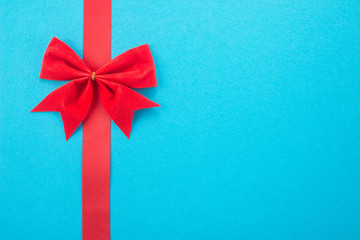  Decorative red ribbon and bow on a blue background 