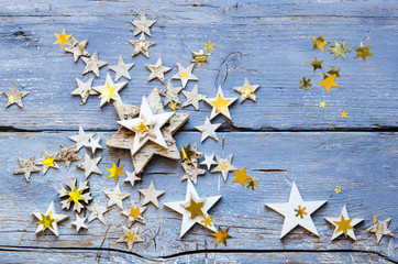 Christmas card with golden and wooden stars on an old blue board :)