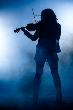 Silhouette of a Rock Woman with Leather Jacket Playing a Violin