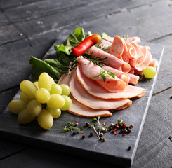 cold meat plate. Sliced ham with lettuce, shallow depth, selective focus
