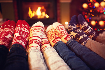 Family in socks near fireplace in winter.