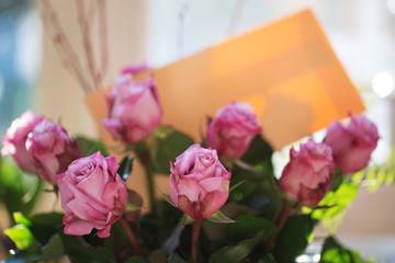 bouquet of pink roses with letter on natural background