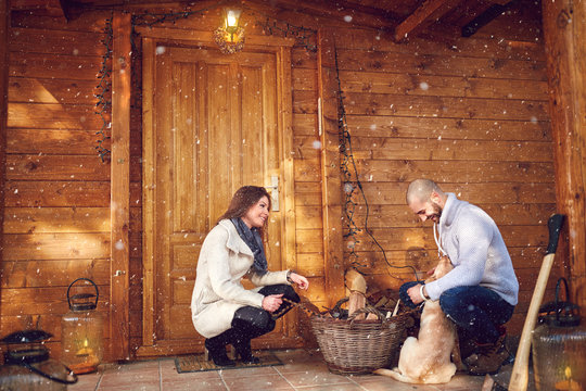 Couple With Dog In Front Of Weekend House