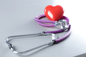 Red heart and a stethoscope on cardiagram
